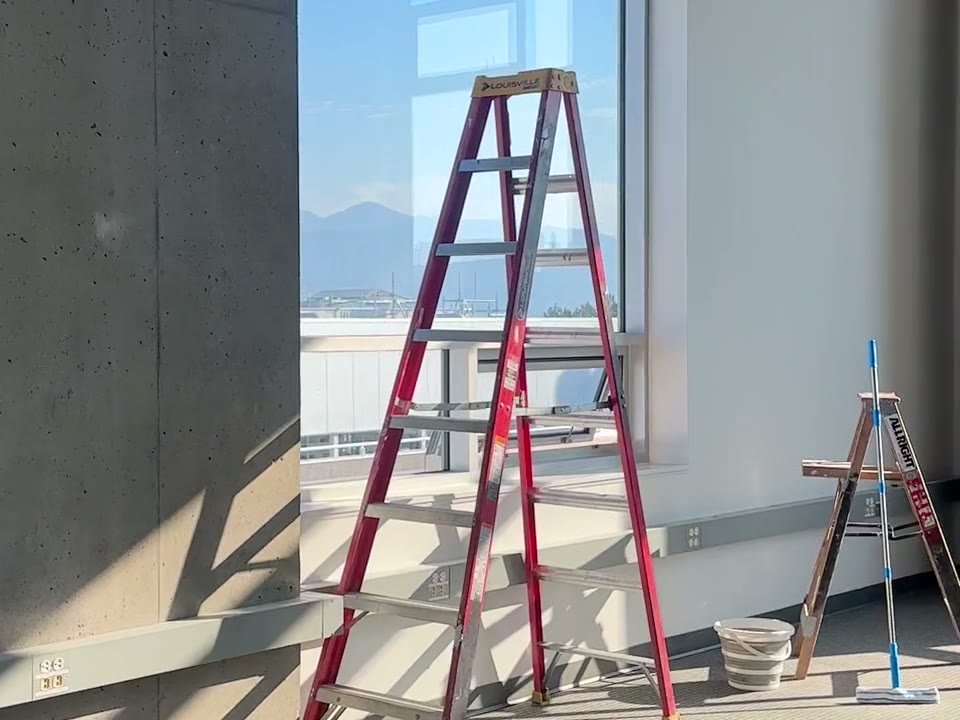 Post-construction cleaning in progress beside a ladder